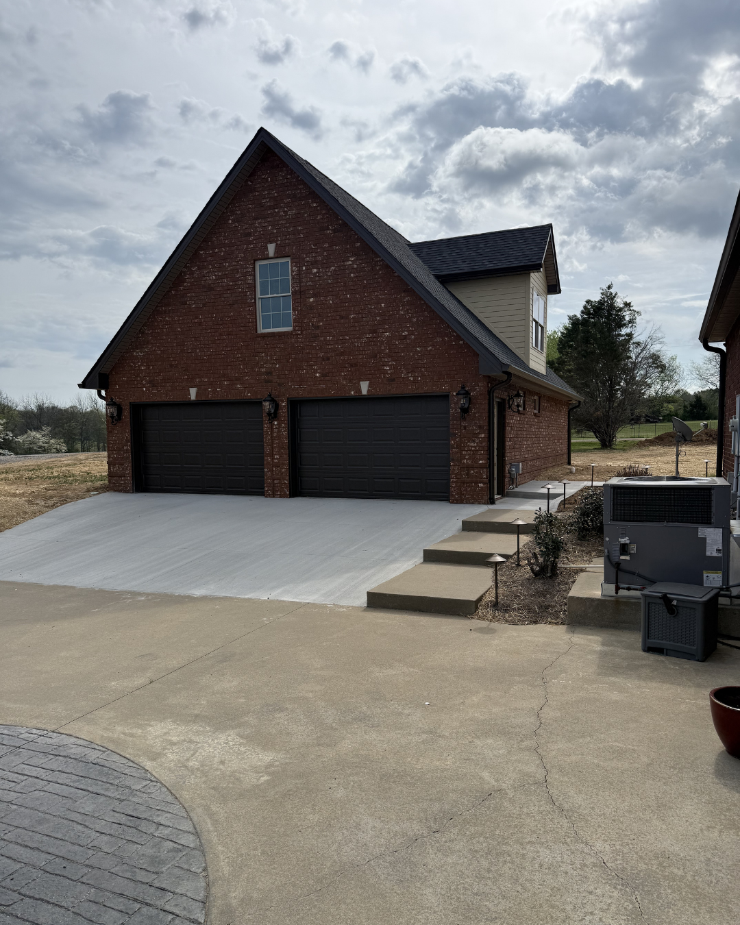 Brick garage addition with stamped concrete driveway — Yarbrough Homes